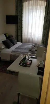a room with a bed and a table with drinks on it at ELG Rooms in Postojna
