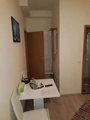 a small room with a white table in a room at ELG Rooms in Postojna