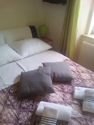 a bed with two pillows on it in a room at ELG Rooms in Postojna