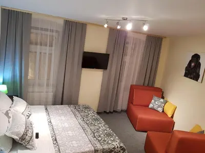 a hotel room with a bed and a chair at ELG Rooms in Postojna