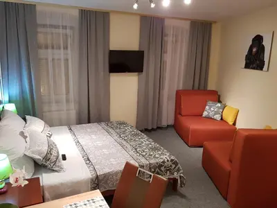 a hotel room with a bed and a chair at ELG Rooms in Postojna