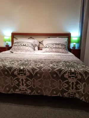 a bedroom with a large bed with two pillows at ELG Rooms in Postojna