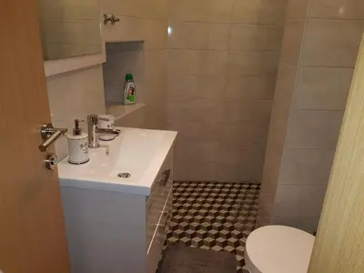 a bathroom with a sink and a toilet at ELG Rooms in Postojna