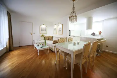 a living room with a white table and a couch at ApartHotel Vila Minka in Ljubljana