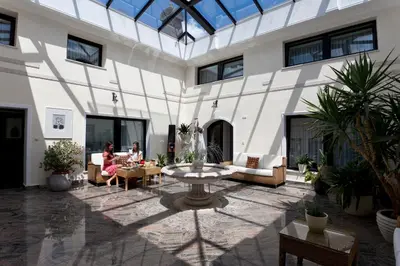a courtyard with a fountain in the middle of a building at ApartHotel Vila Minka in Ljubljana
