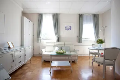 a living room with a couch and a table at ApartHotel Vila Minka in Ljubljana