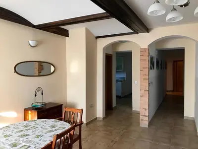 a dining room with a table and chairs and a mirror at Bled Home in Bled