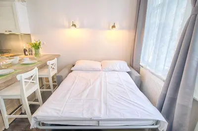 a small room with a bed and a table at Sweet 16 Studio in Ljubljana