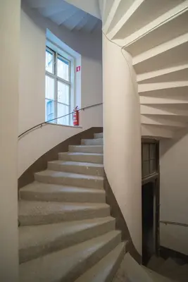 a staircase in an old building with a window at Sweet 16 Studio in Ljubljana