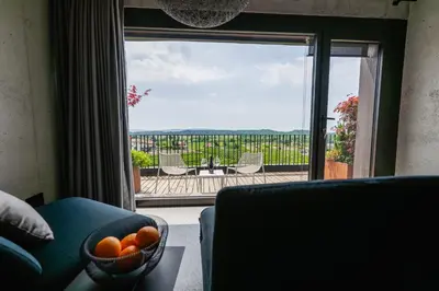 a room with a couch and a window with a view at Fana Estate in Dobrovo