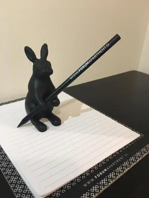 a small black rabbit holding a baseball bat at FORUM Apartment I and II in Ljubljana
