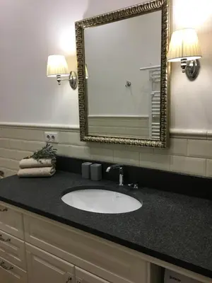 a bathroom with a sink and a mirror at FORUM Apartment I and II in Ljubljana