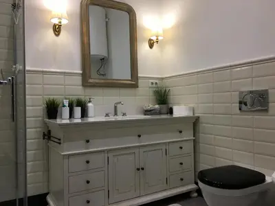 a bathroom with a sink and a toilet and a mirror at FORUM Apartment I and II in Ljubljana