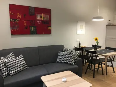 a living room with a couch and a table at FORUM Apartment I and II in Ljubljana