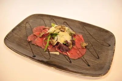 a plate of food with meat and cheese on it at Hotel Venko in Dobrovo