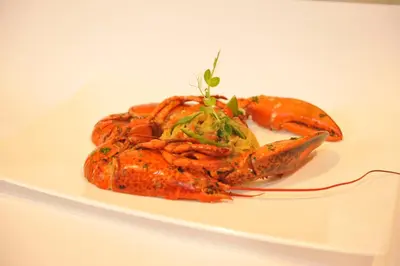 a plate of food with carrots on a white plate at Hotel Venko in Dobrovo