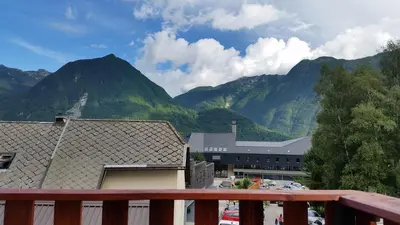 a view of a mountain range from a balcony at Thirsty River Rooms in Bovec