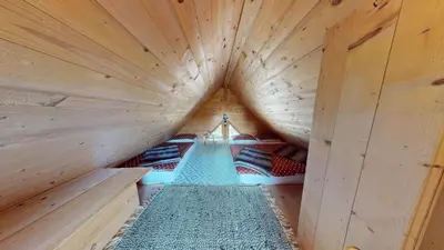 a large wooden cabin with beds in it at Resort Hisa Ida - Apartments with Hot Tub and Sauna in Ivančna Gorica