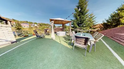 a patio with a gazebo and a table and chairs at Resort Hisa Ida - Apartments with Hot Tub and Sauna in Ivančna Gorica