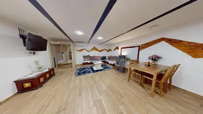 a living room with a table and a tv at Resort Hisa Ida - Apartments with Hot Tub and Sauna in Ivančna Gorica
