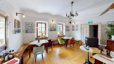a living room with tables and chairs and a television at Resort Hisa Ida - Apartments with Hot Tub and Sauna in Ivančna Gorica
