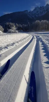 a pair of skis on a snow covered road at Zajček Apartma in Mojstrana