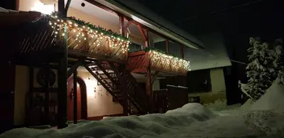 a building with christmas lights on the side of it at Zajček Apartma in Mojstrana