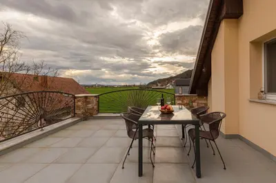 a patio with a table and chairs on a balcony at Apartment Tati in Dol pri Ljubljani
