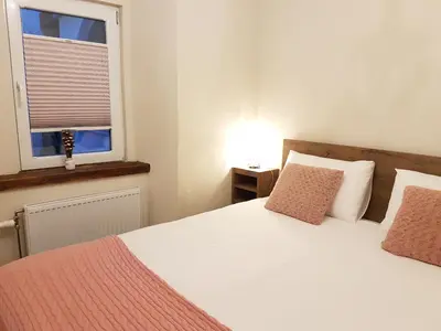a bedroom with a bed with two pillows and a window at Romantic Apartments Sweet Baci in Maribor