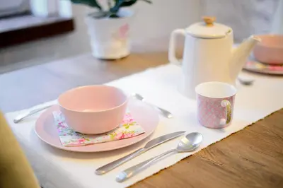 a table with a cup and a plate with a tea pot at Romantic Apartments Sweet Baci in Maribor