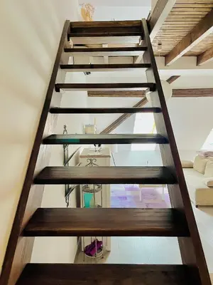 a wooden staircase with glass treads in a house at Romantic Apartments Sweet Baci in Maribor