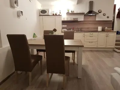 a kitchen with a dining room table and chairs at Romantic Apartments Sweet Baci in Maribor