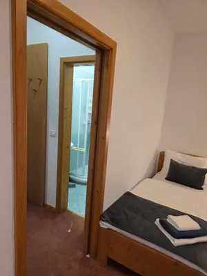 a small bedroom with a bed and a mirror at Hotel Rakov Skocjan in Cerknica