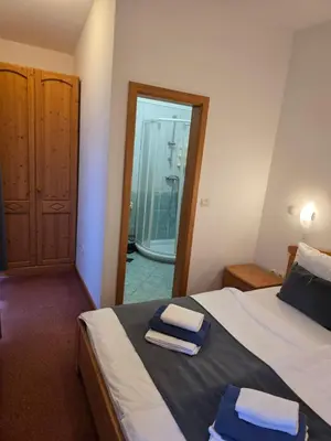 a bedroom with a bed with two towels on it at Hotel Rakov Skocjan in Cerknica