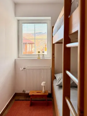a small room with a bed and a window at Apartments Žnidar in Spodnje Gorje