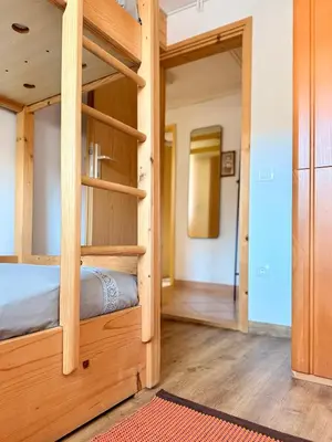 a room with a bunk bed and a hallway at Apartments Žnidar in Spodnje Gorje