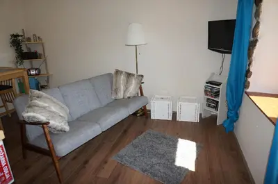 a living room with a couch and a tv at Valley View Apartment in Kambreško