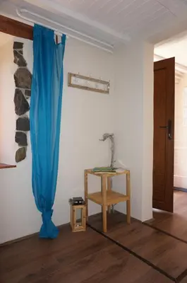 a room with a blue curtain and a table at Valley View Apartment in Kambreško