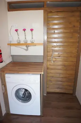 a washer and dryer in a tiny house at Valley View Apartment in Kambreško