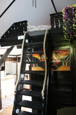 a wooden staircase with rope and flowers on it at Frenkcottage 5 KM FROM THE AIRPORT- FREE TRANSPORTATION TO THE AIRPORT in Šenčur