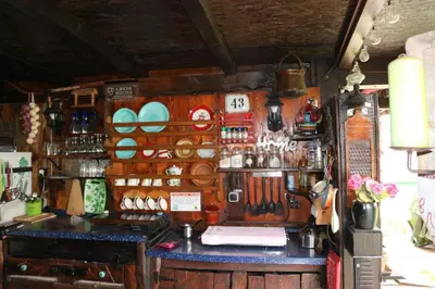 a shop with a counter with utensils on the wall at Frenkcottage 5 KM FROM THE AIRPORT- FREE TRANSPORTATION TO THE AIRPORT in Šenčur