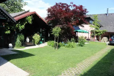 a house with a lawn in front of a house at Frenkcottage 5 KM FROM THE AIRPORT- FREE TRANSPORTATION TO THE AIRPORT in Šenčur