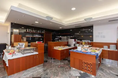 a restaurant with a buffet line with food on display at Garni Hotel Azul in Kranj