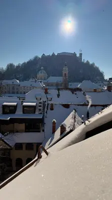 a snow covered roof of a city with buildings at i Design Studio in Ljubljana