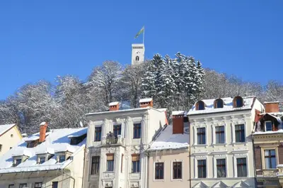 a white building with snow on top of it at i Design Studio in Ljubljana