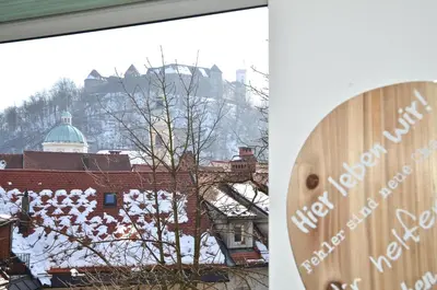 a view from a window of a building with a tree at i Design Studio in Ljubljana