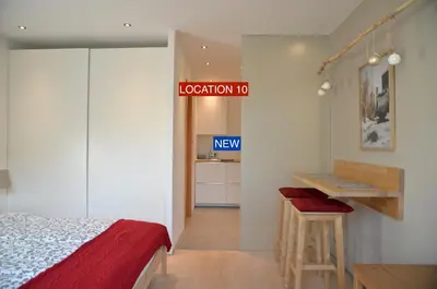 a bedroom with a bed and a sign that reads location to new at i Design Studio in Ljubljana