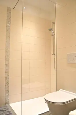 a bathroom with a shower and a toilet at i Design Studio in Ljubljana