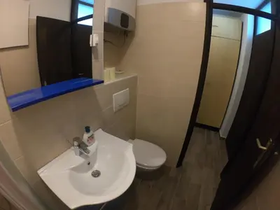 a bathroom with a white sink and a toilet at Monolocale Belvedere in Bovec