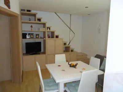 a dining room with a white table and chairs at Holiday Home Neokrnjena Narava in Sevnica